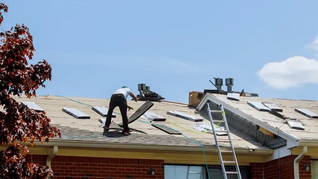 Roofing professional inspecting a residential roof in Olympia, WA