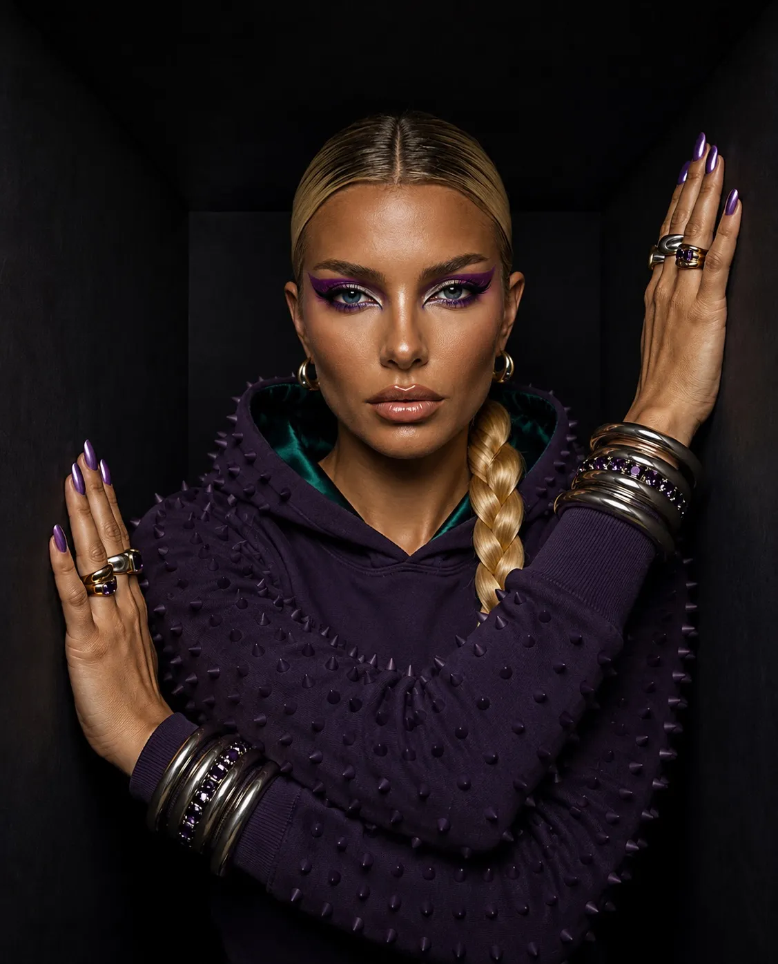 Woman wearing a deep purple JEEYODEE Thorns hoodie against a black background