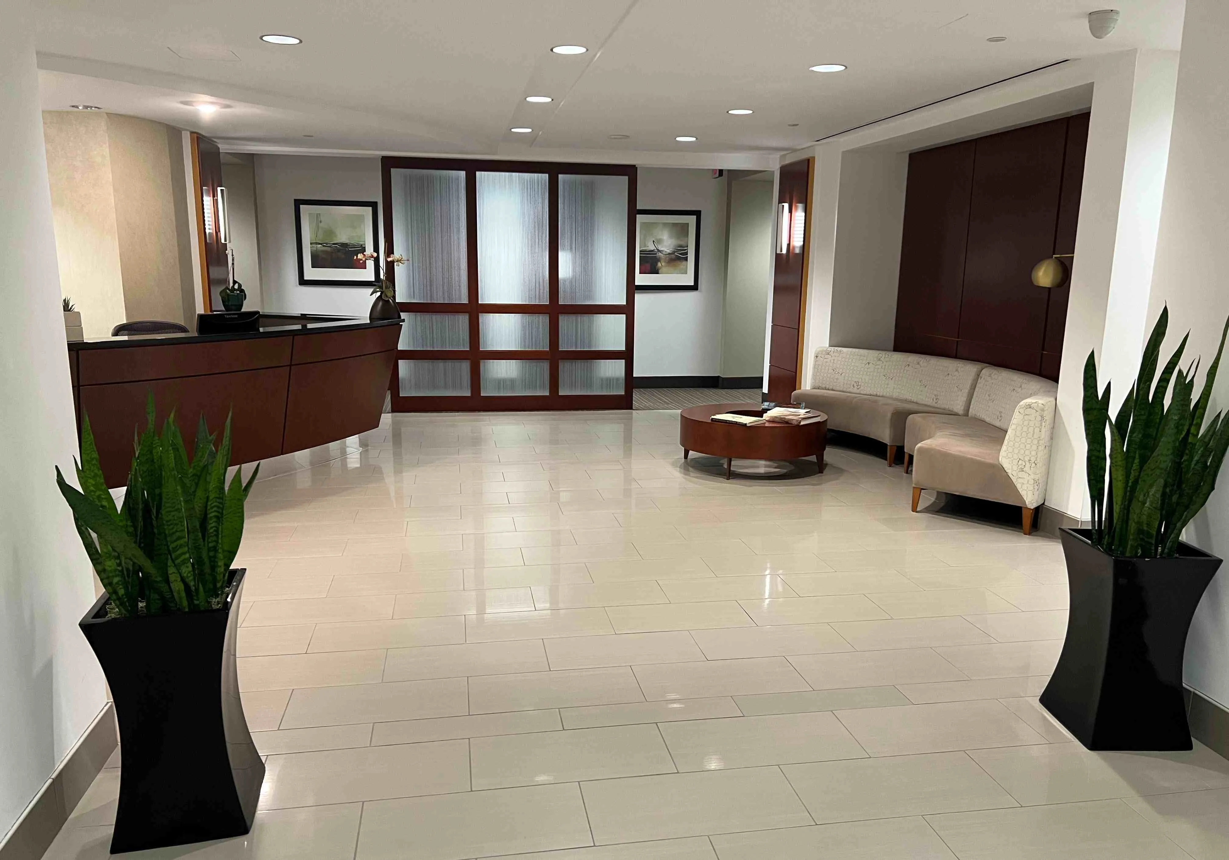 Welcoming reception area of a skincare clinic with a friendly receptionist