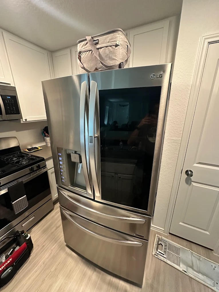 ### Main Subject - **Refrigerator**: A large, stainless steel LG refrigerator with a modern design.