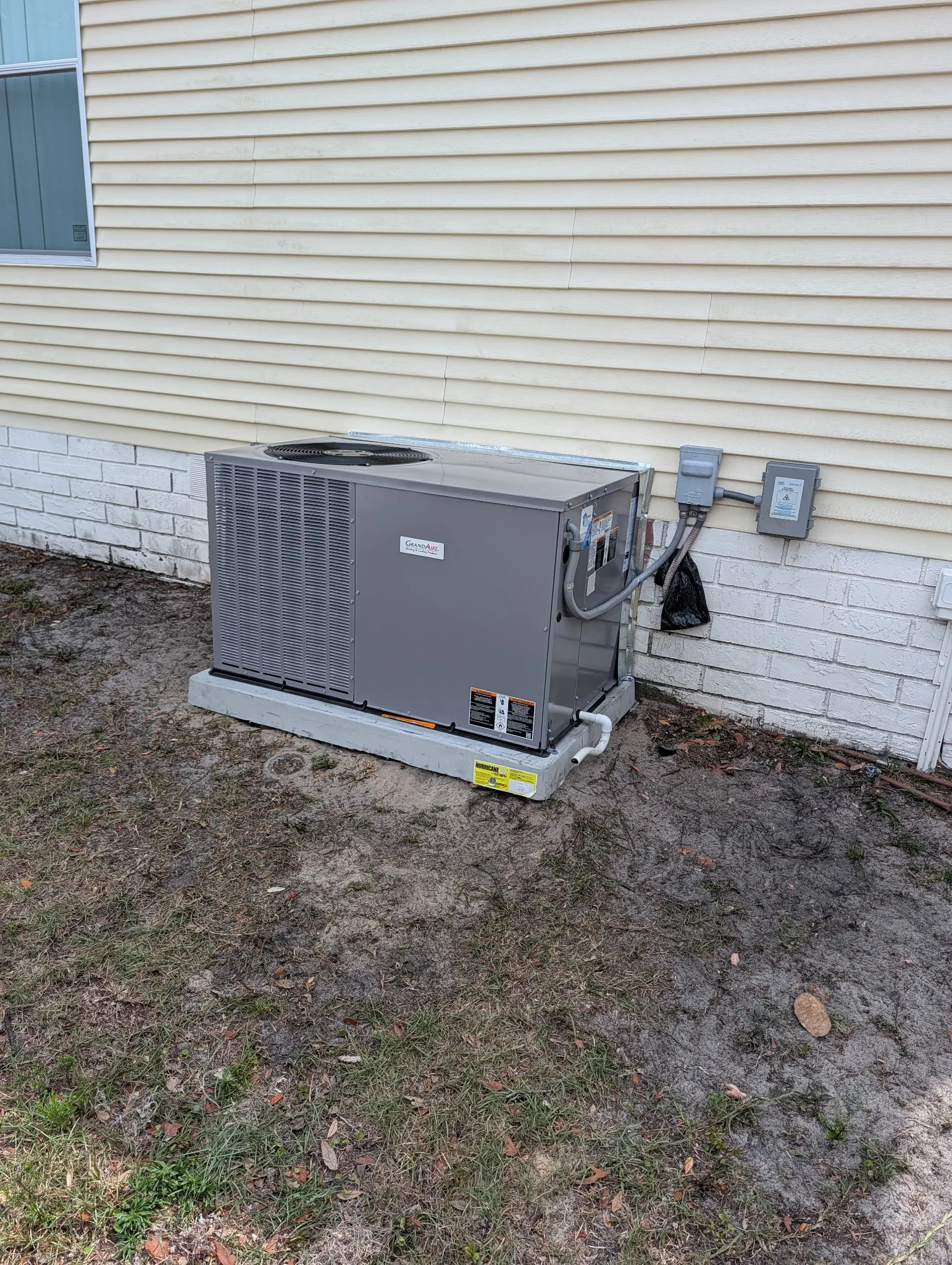 Outdoor AC compressor unit showing signs of mechanical failure
