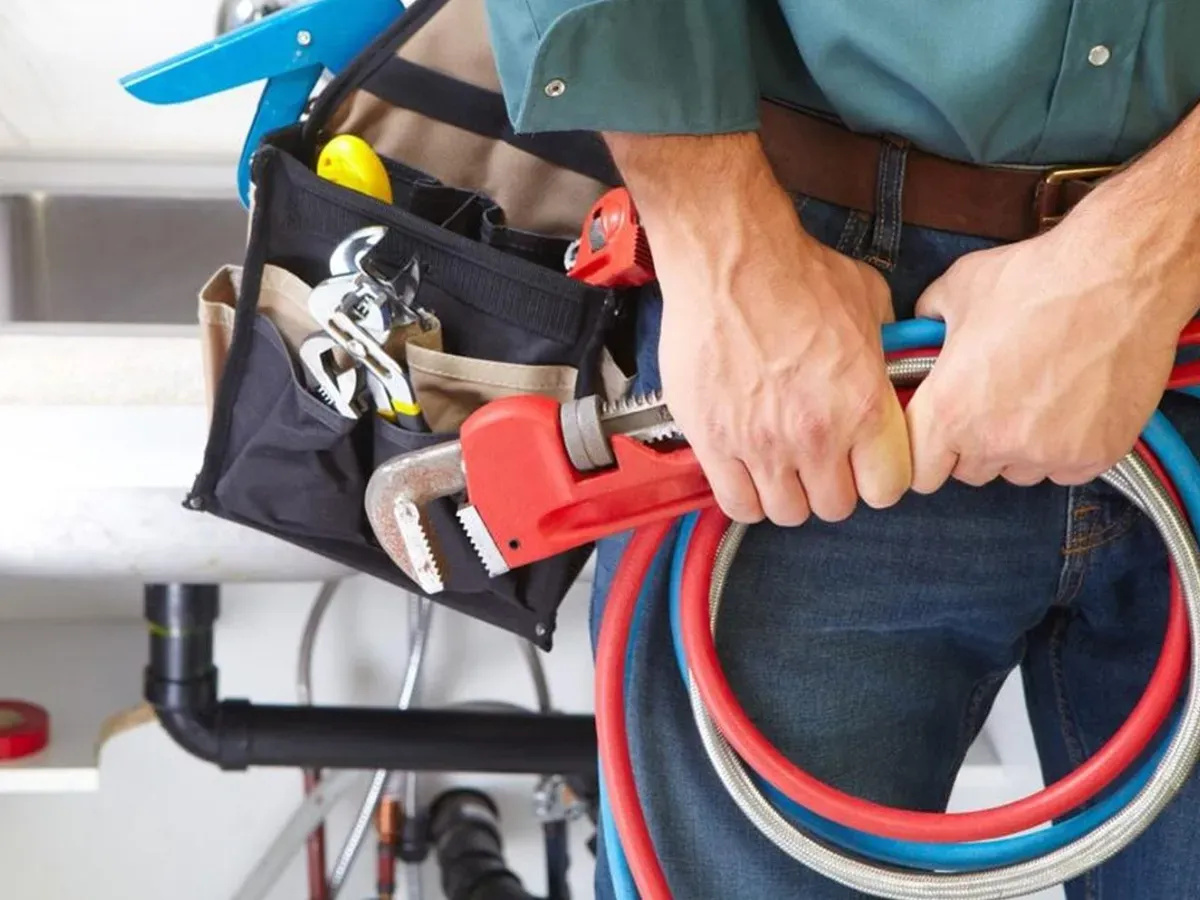 Person turning off the main water supply during a plumbing emergency
