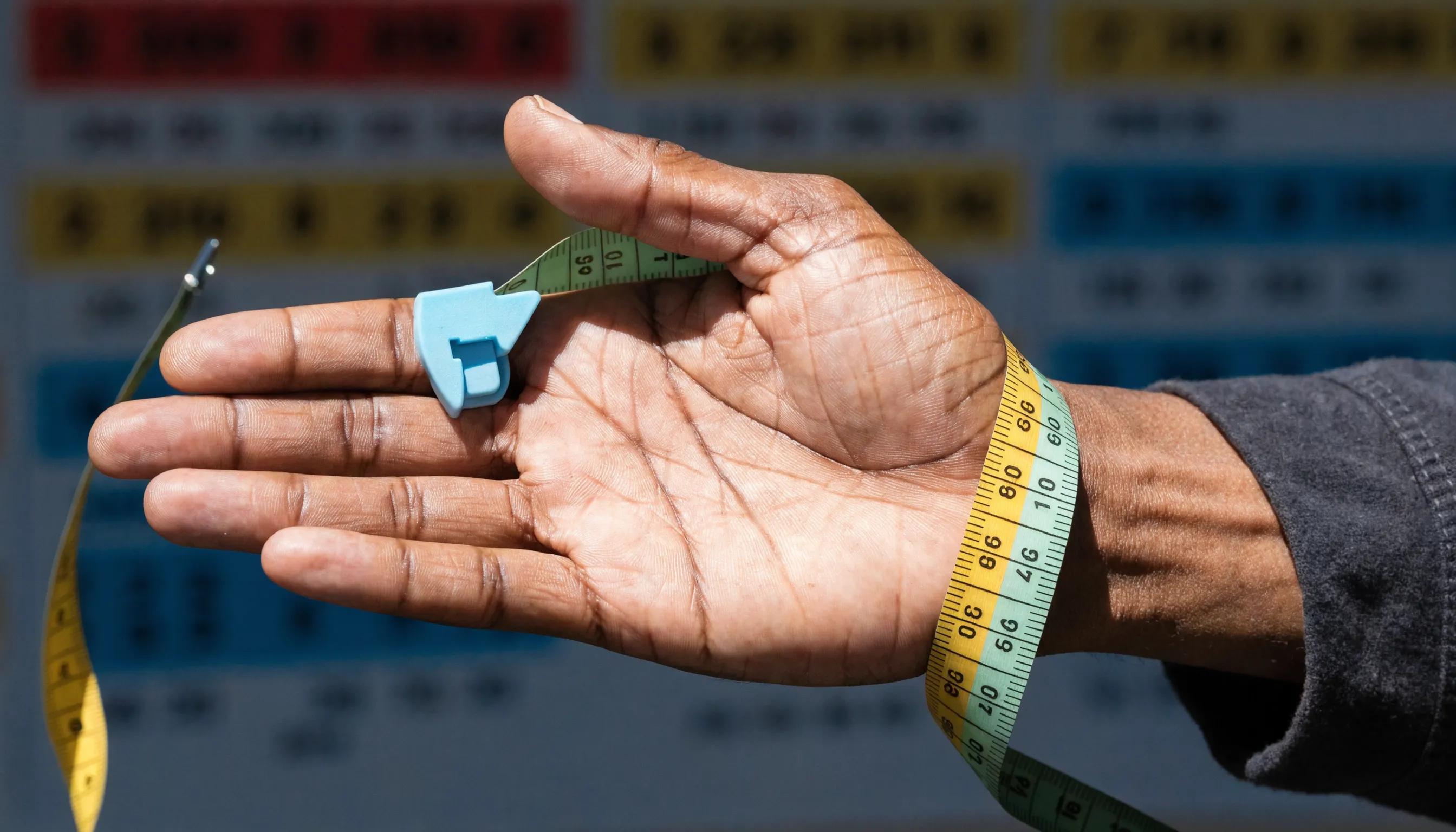 Close-up of hand measuring for glove fit accuracy Close-up of hand measuring for glove fit accuracy