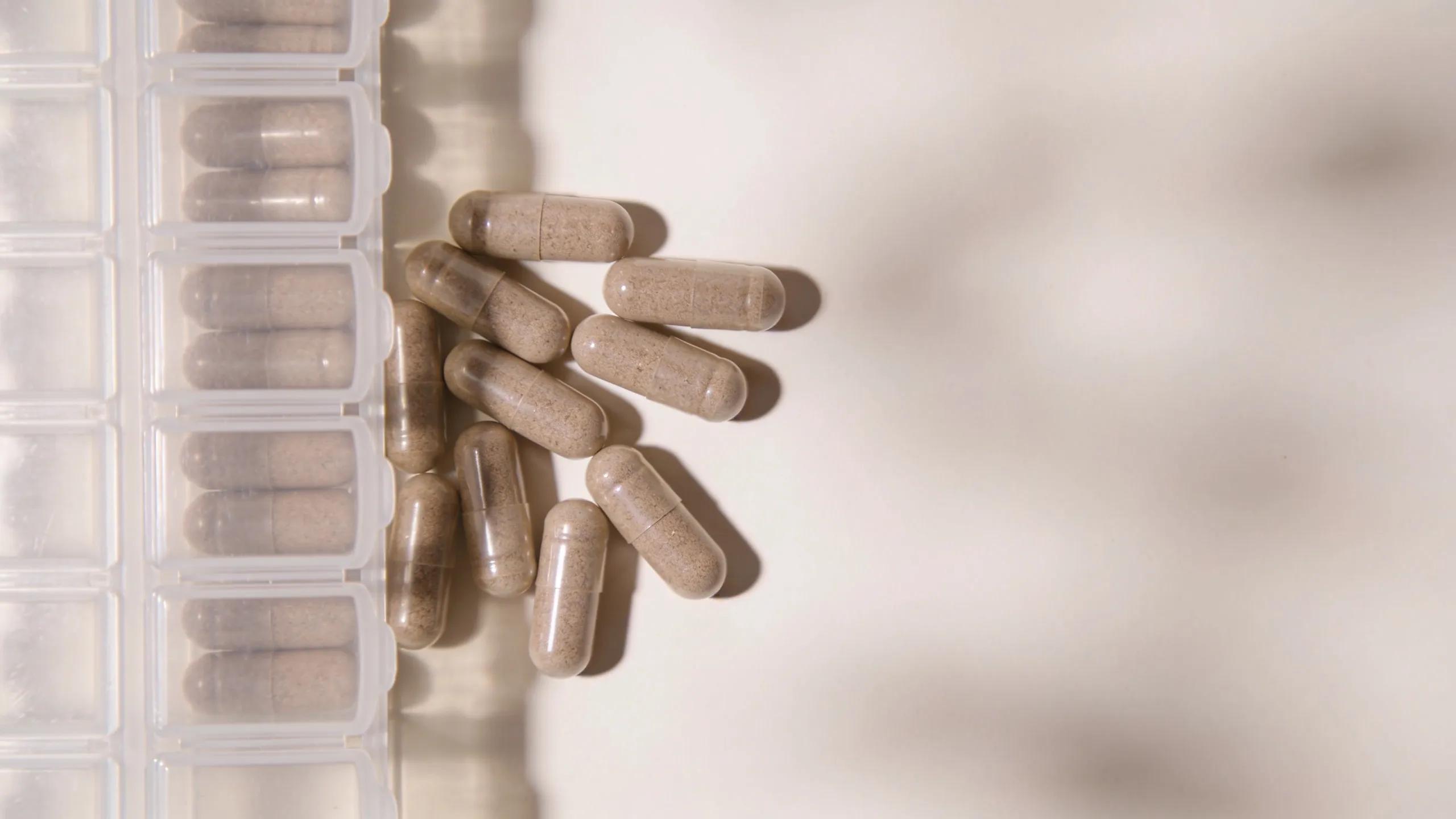 Daily dosage of organic beef liver capsules in a pill organiser emphasising proper health guidelines