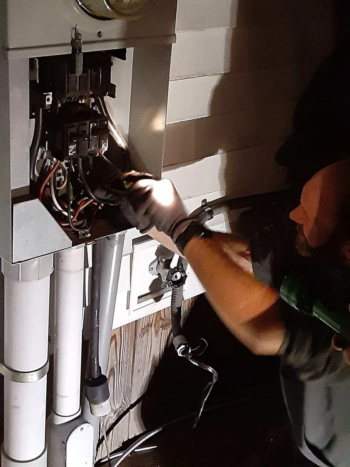 Electrician inspecting wiring in a Marietta home near the Ohio River, emphasizing reliable local electrical services