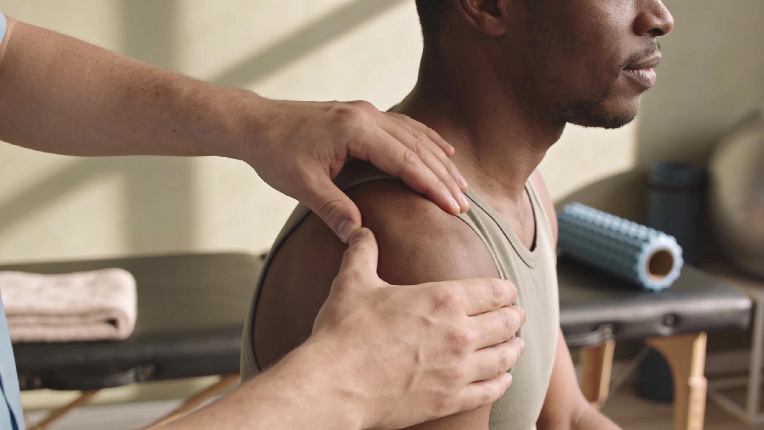 A physical therapist demonstrating manual therapy techniques to a patient during their rehabilitation process