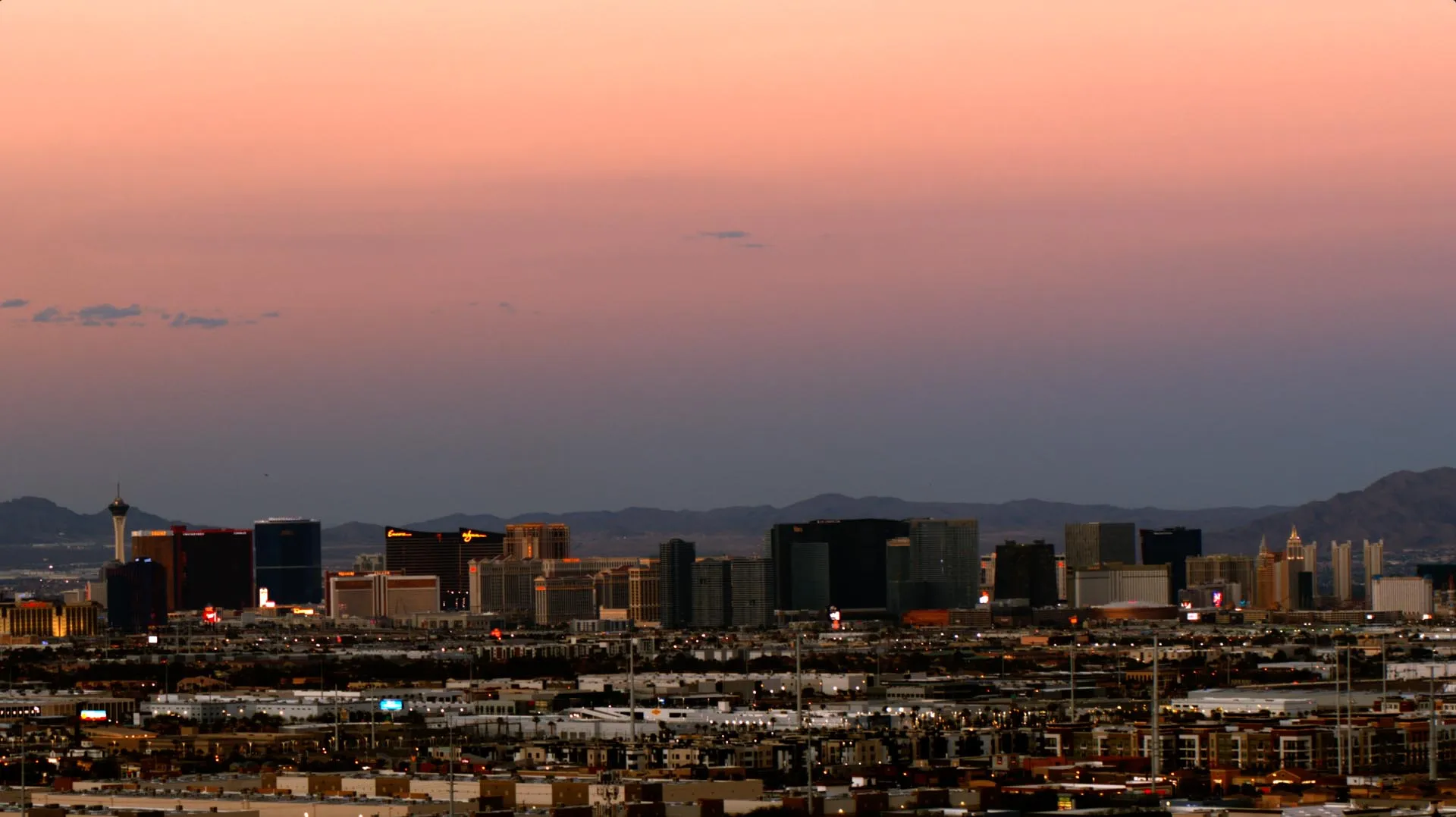Las Vegas skyline at sunset with colorful sky and distant mountains