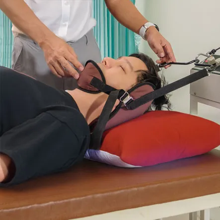 Chiropractor performing a spinal adjustment on a patient in a chiropractic clinic