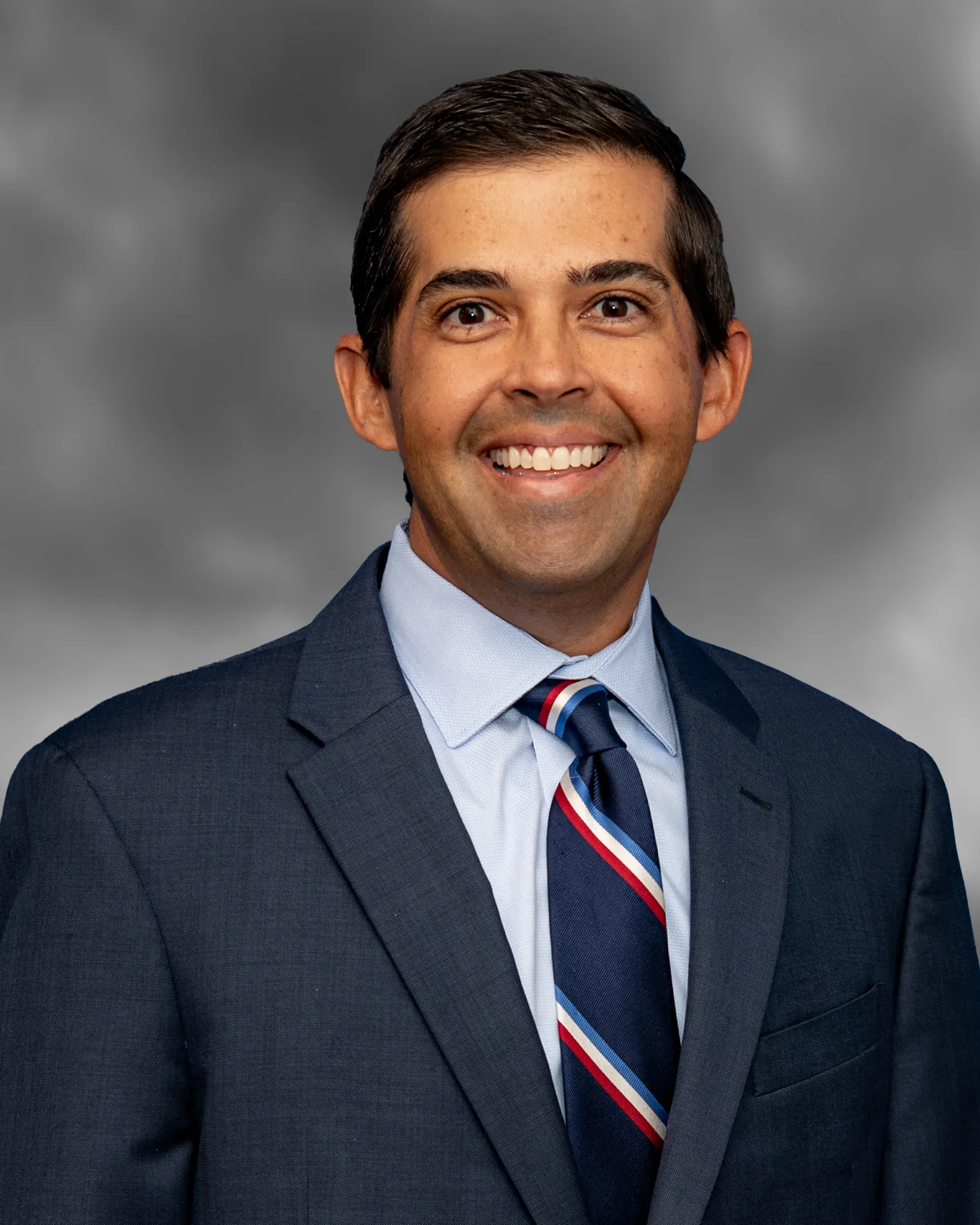 Dr. Arun Rao in a suit, board-certified plastic surgeon at Rao Plastic Surgery