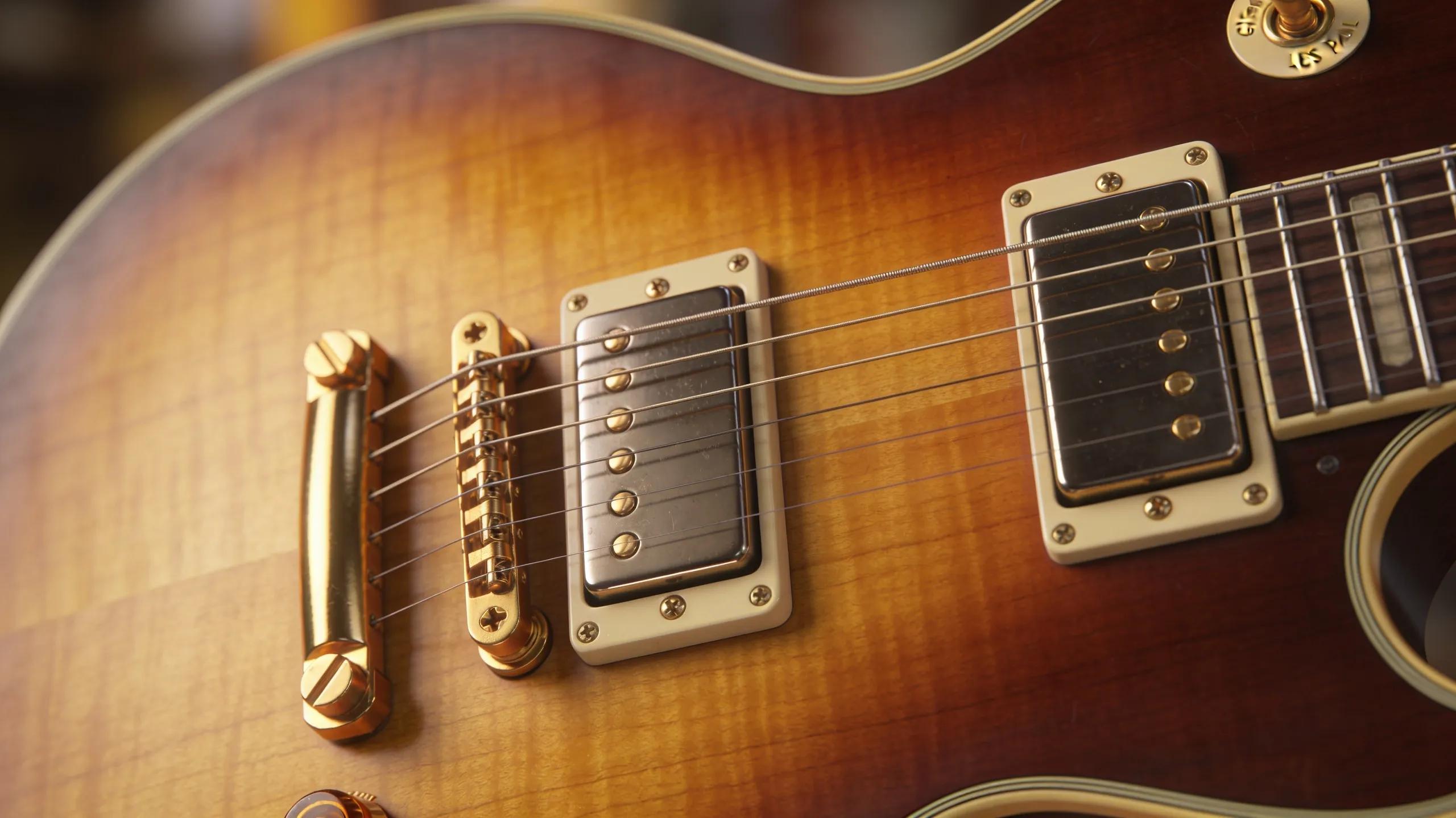 Detailed view of a Gibson Les Paul guitar focusing on its body and humbucker pickups