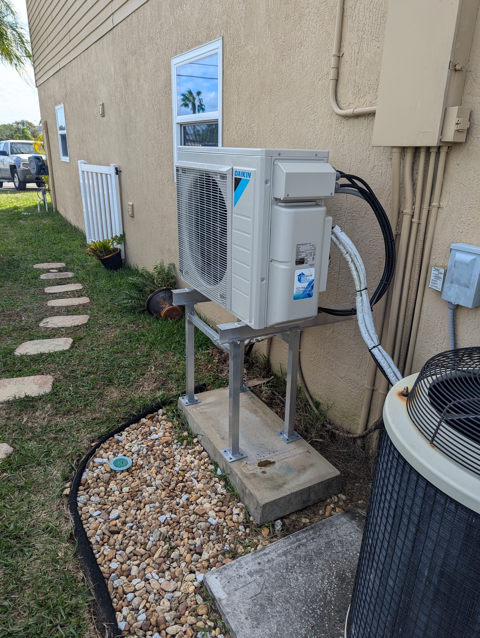 Newly installed outdoor AC unit selected and mounted by licensed contractors to support better energy efficiency and system performance.