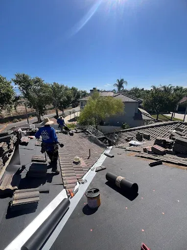 Professional roofing team installing a metal roof on a Southern California residential home