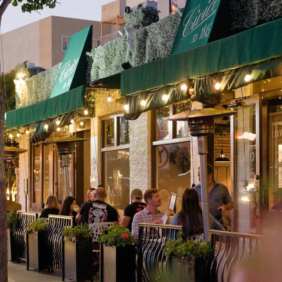 Guests dining on the Civico 1845 patio in Little Italy, San Diego