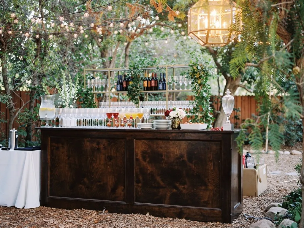 wedding bar setup with staged cocktail glasses wine glasses and champagne flutes in elegant event