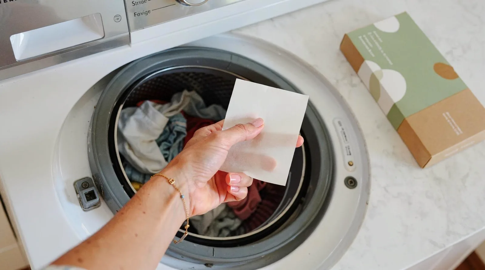 You can simply place a sheet directly into the washing machine with your clothing