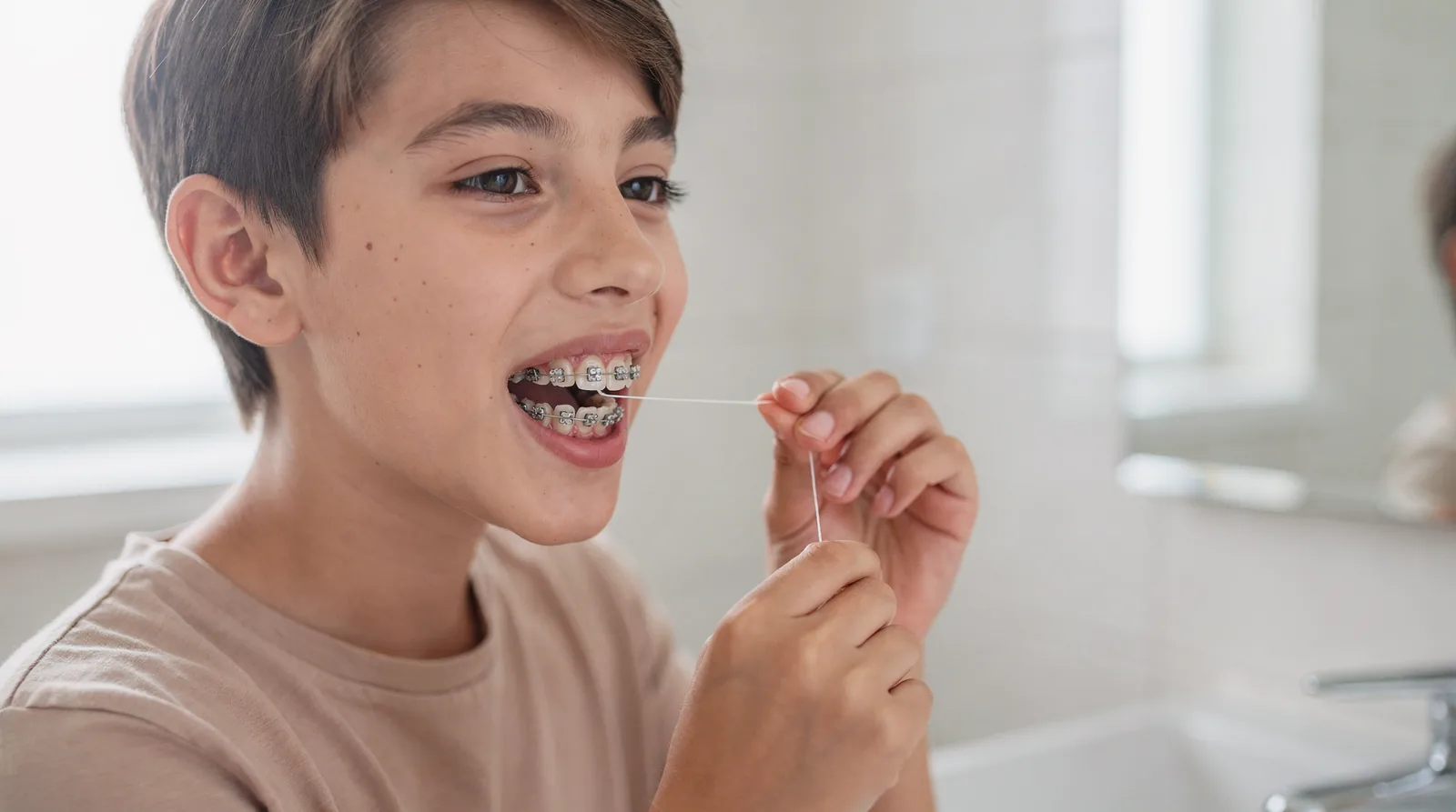 A water pick is often the easiest way to clean around brackets and wires when