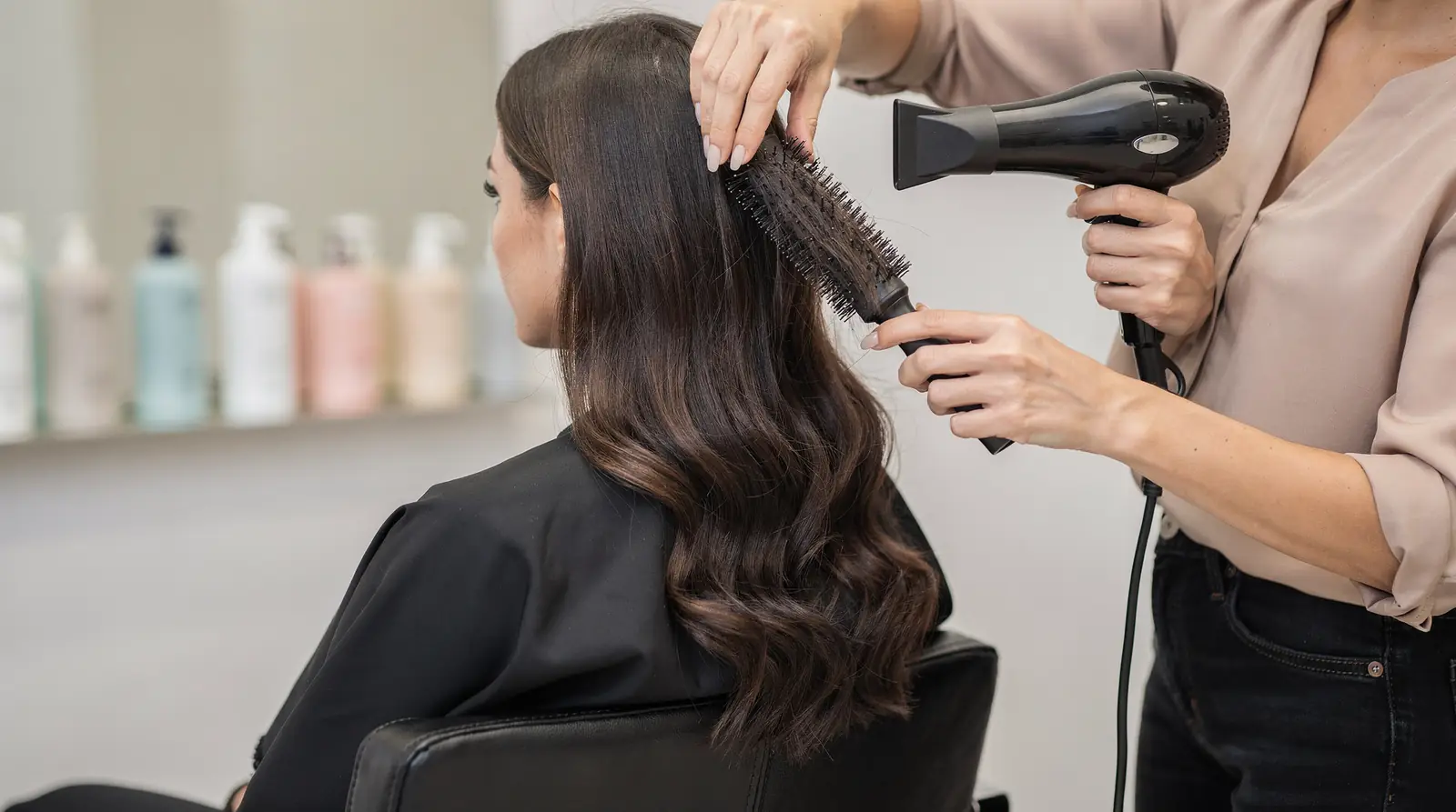 A proper blowout routine starts in the shower, since hair must be shampooed and wet