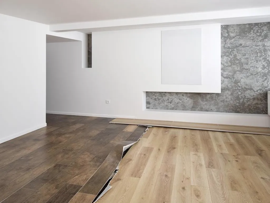 Mismatched flooring transition strip placed awkwardly mid-room