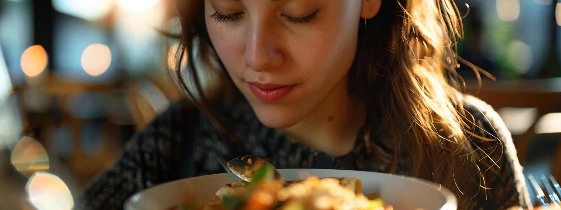 a person sitting at a table, eyes closed, savoring each bite of food with a look of concentration and calmness.