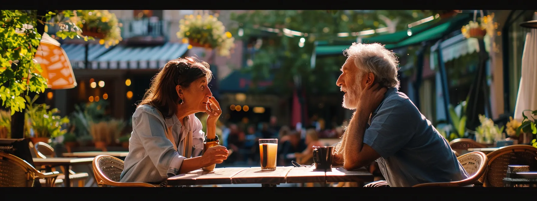 two people sitting at a café table, one speaking spanish and the other speaking english, engaged in a lively conversation.