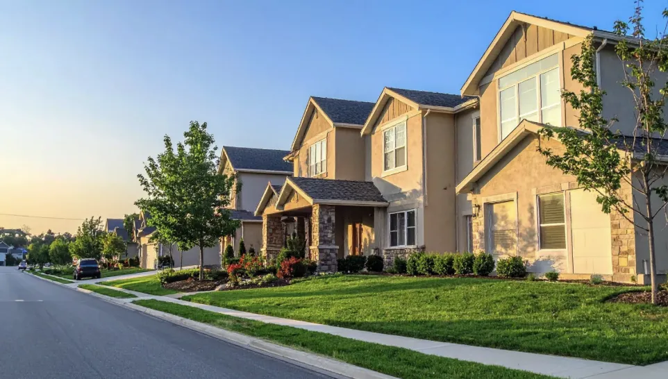 row of suburban homes, with sunshine and manicured lawns row of suburban homes, with sunshine and manicured lawns