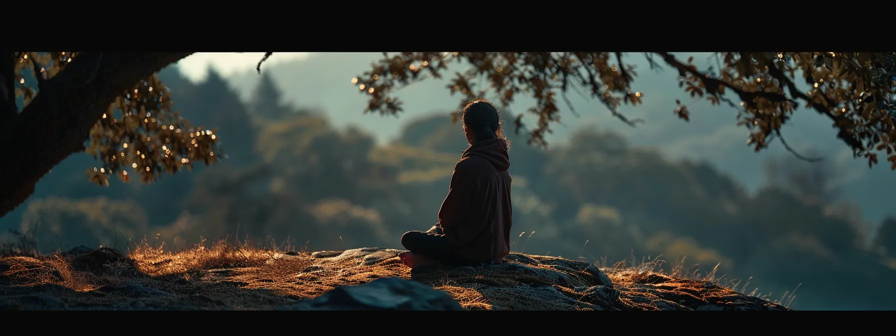 a person sitting peacefully in a serene natural setting, focusing on their mental and emotional well-being.