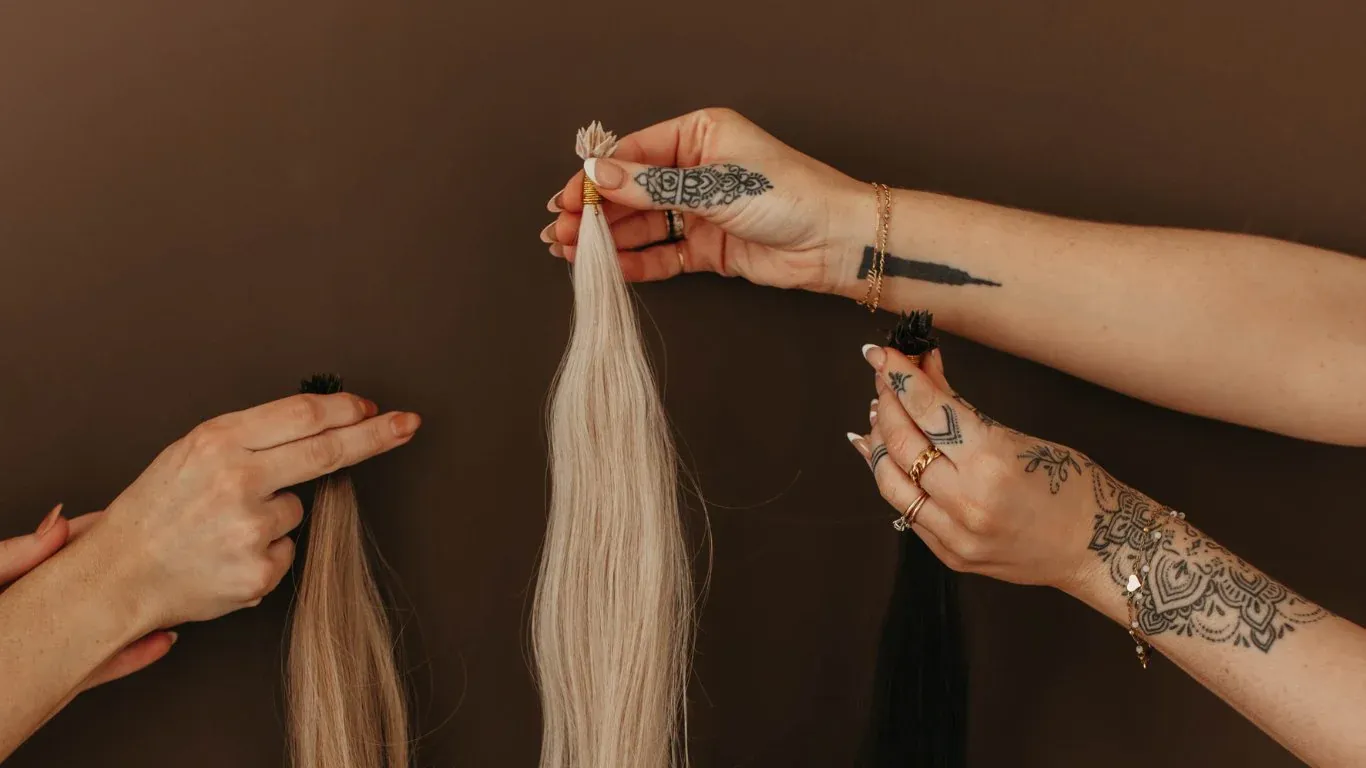 hands holding extension wefts hands holding extension wefts