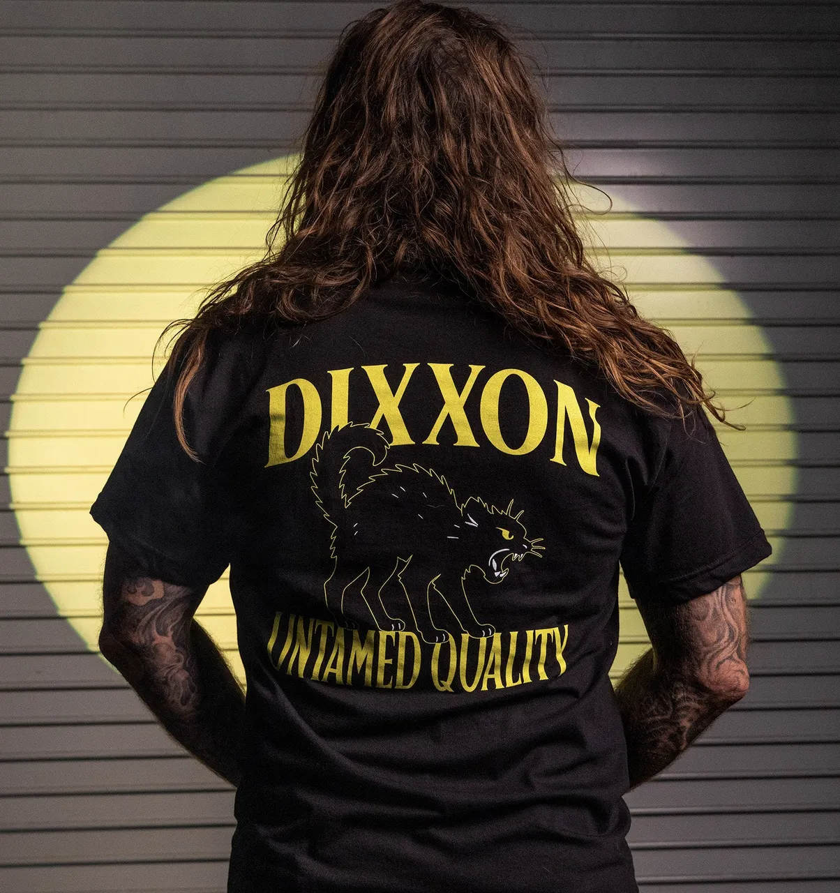 Man turned around showing the back of Dixxon's Untamed Quality T-Shirt