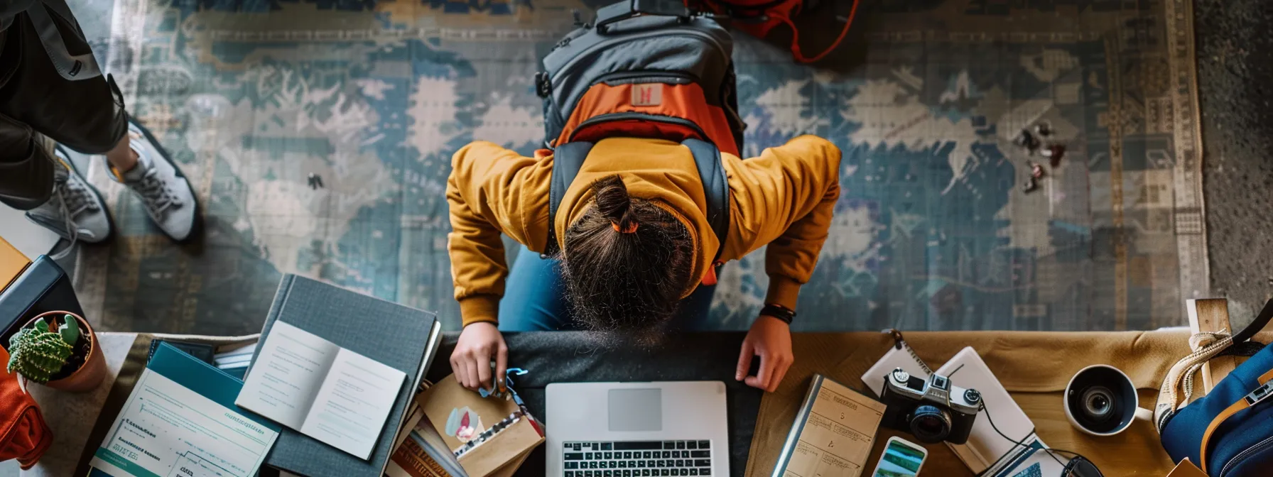 a student packing for an academic journey, surrounded by travel essentials and books, with an sta travel insurance brochure on the table.