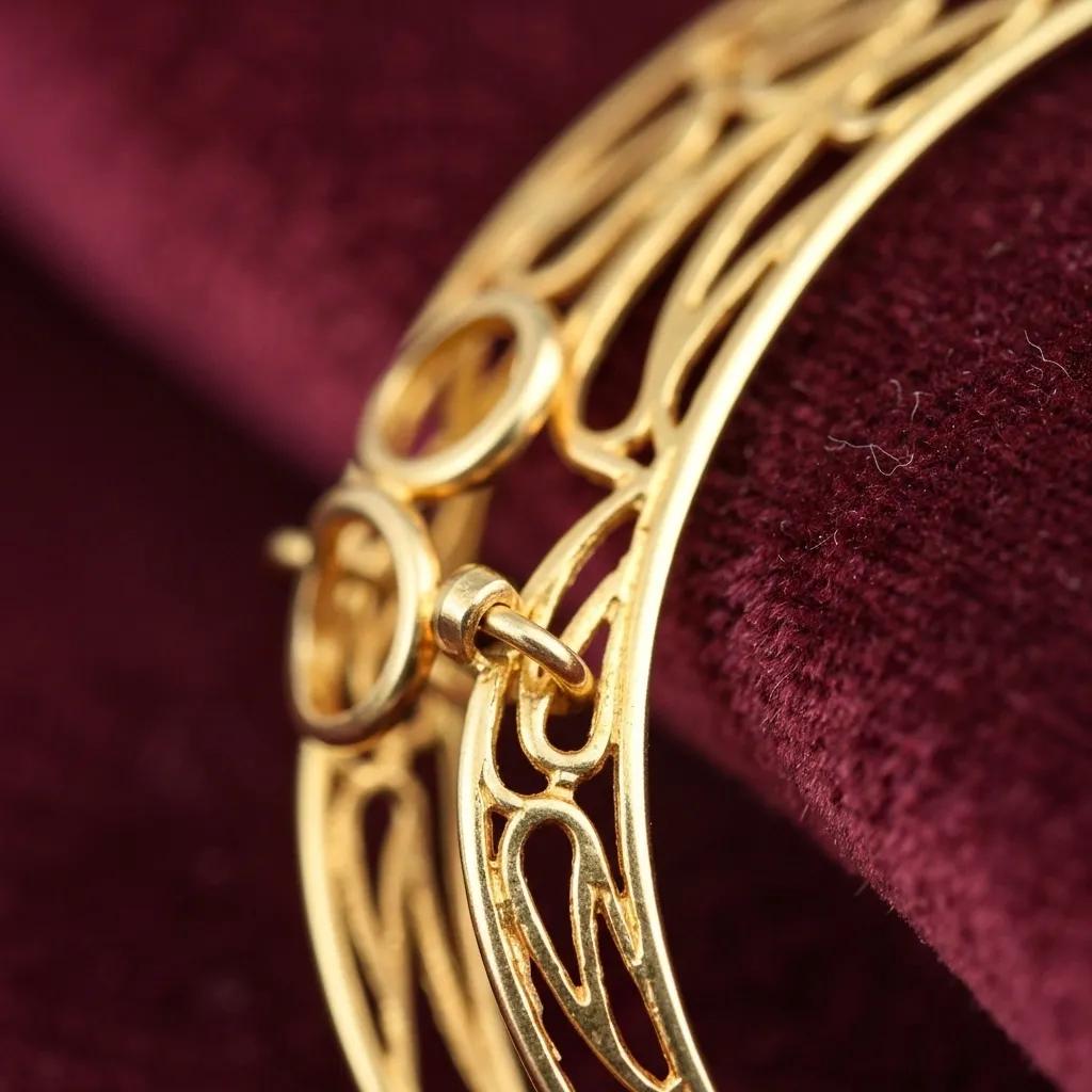 A close-up view of a gold-plated piece of jewellery, highlighting its lustrous surface and intricate detailing within a luxurious setting