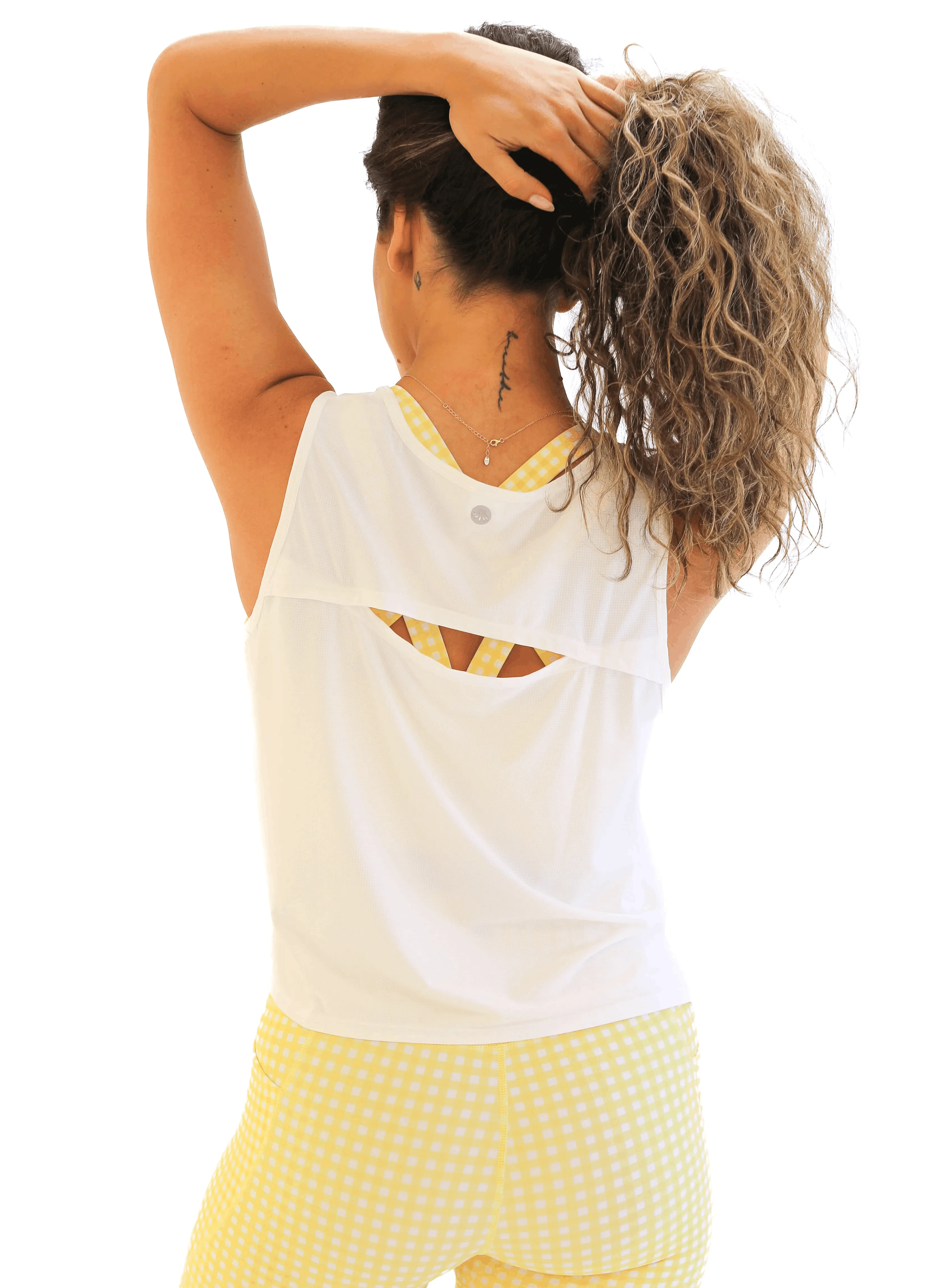 Woman holding hands on head showing the back of Breathetech Open Back Tank - White back