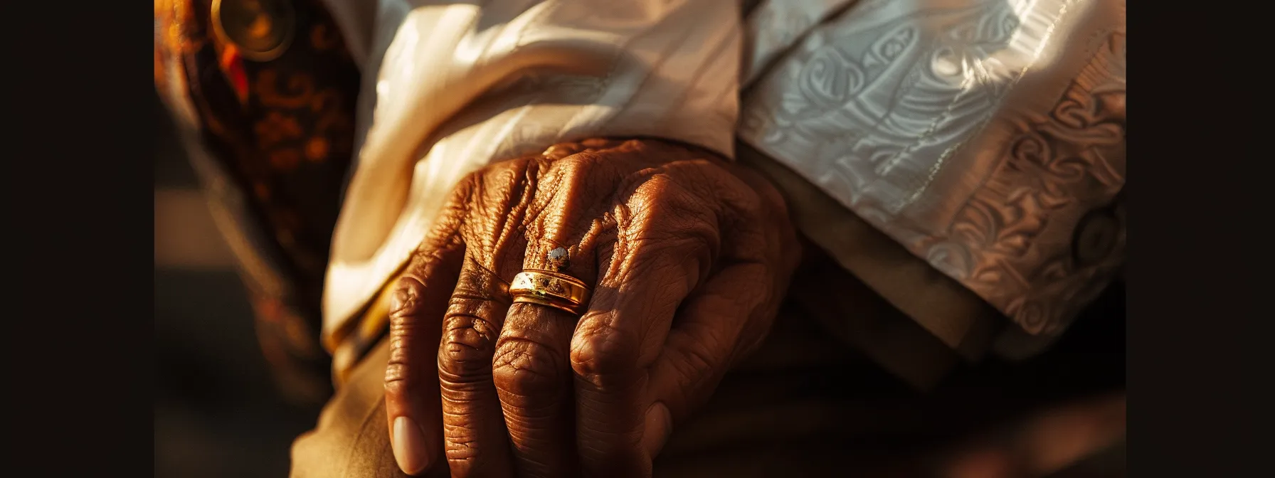 a close-up of a man's hand adorned with a bold and distinctive ring, symbolizing wealth and personal style throughout history.