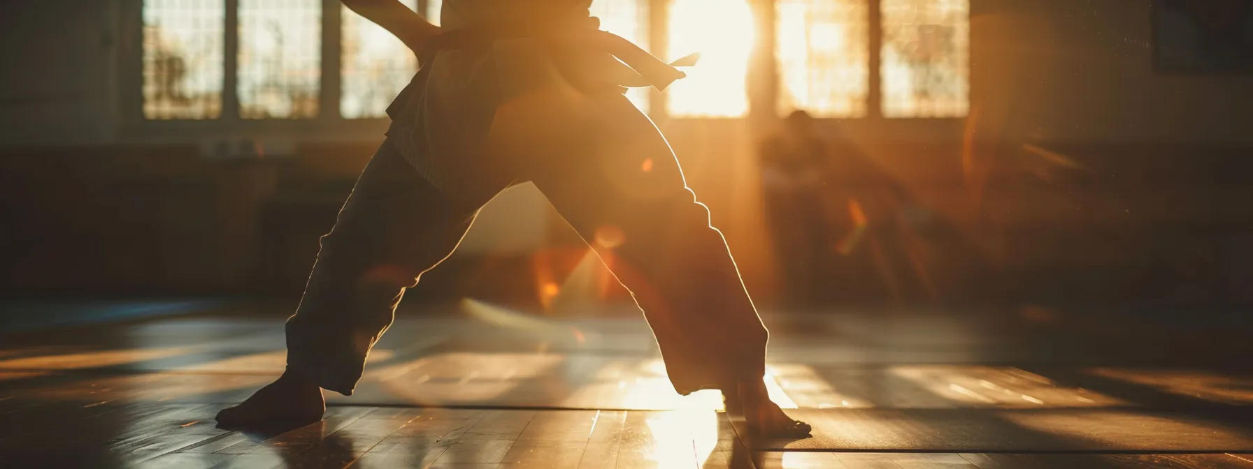 a person performing dynamic warm-up stretches before a martial arts training session.