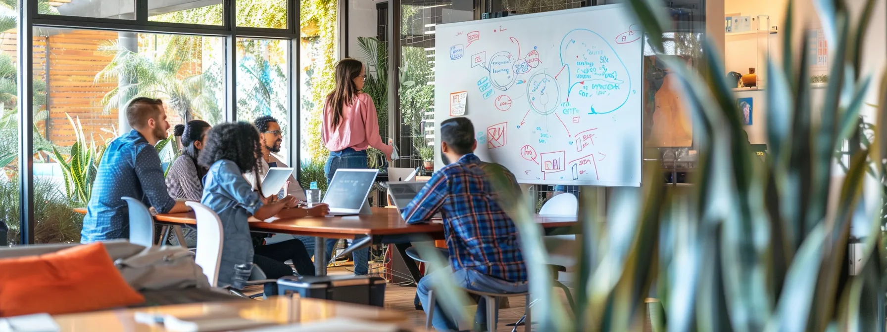 a modern office space with a diverse team brainstorming seo strategies on a whiteboard.