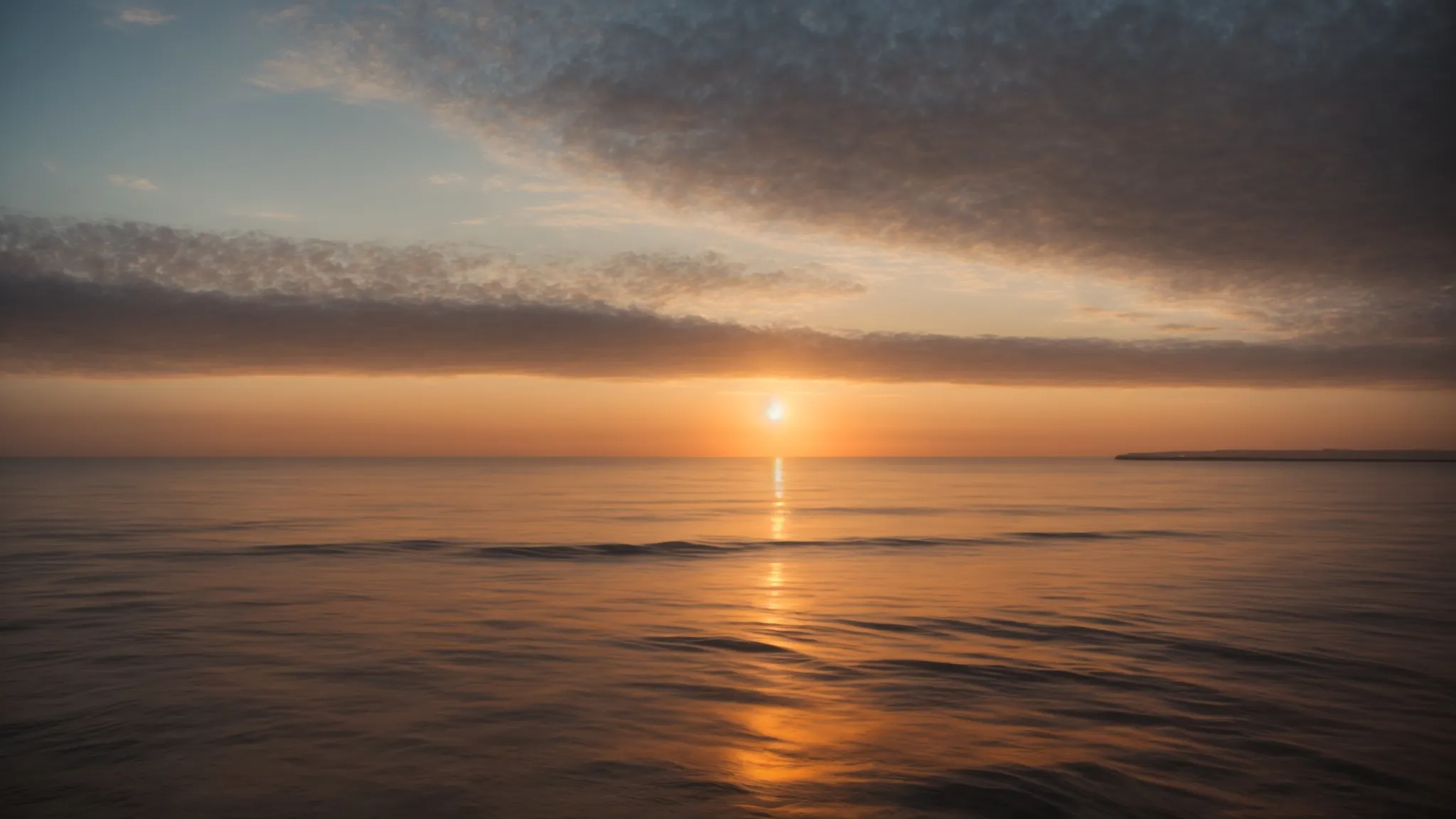 a wide-angle shot of a serene sunrise over a calm sea, symbolizing new beginnings and the journey towards success.