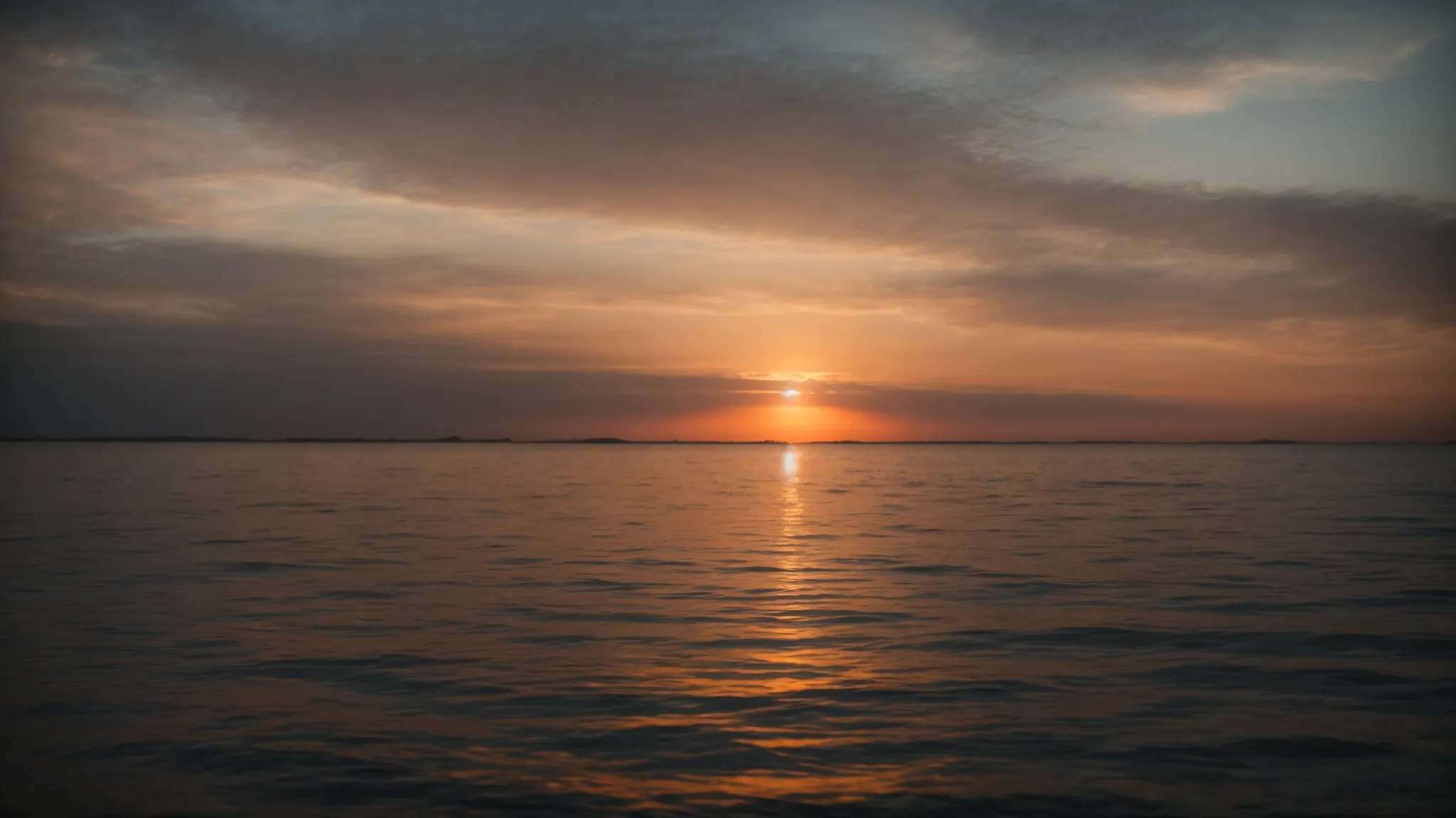 a glowing sunrise over a calm sea, symbolizing hope and the beginning of a journey towards financial security.