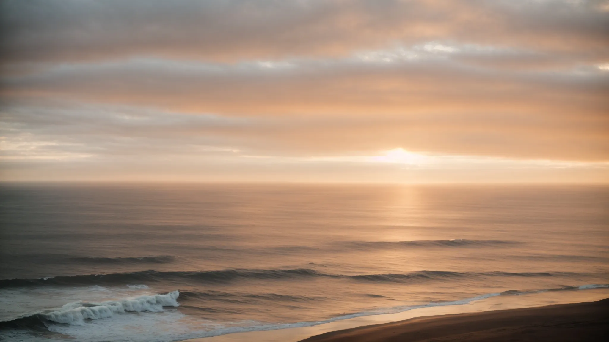 a camera points towards a vast ocean at sunrise, symbolizing new beginnings.