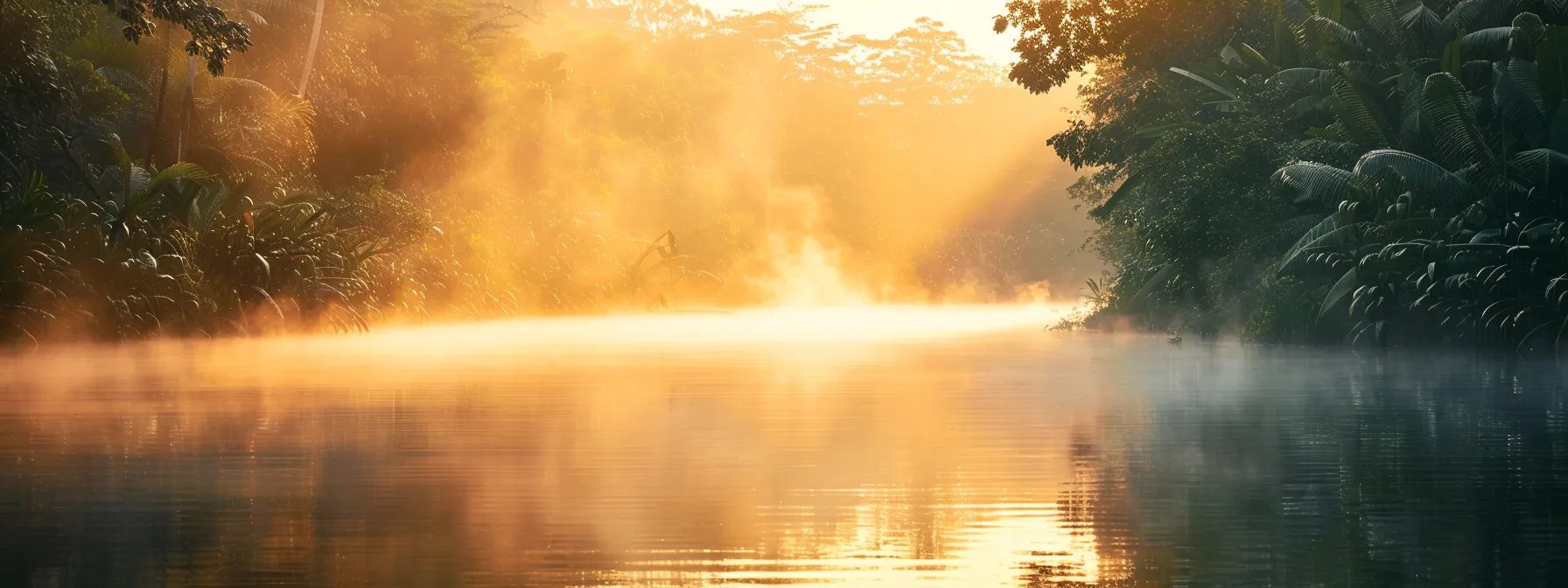 a breathtaking sunrise casts golden hues over a tranquil lake, where mist gently rises from the water's surface, creating a serene reflection of surrounding lush greenery.