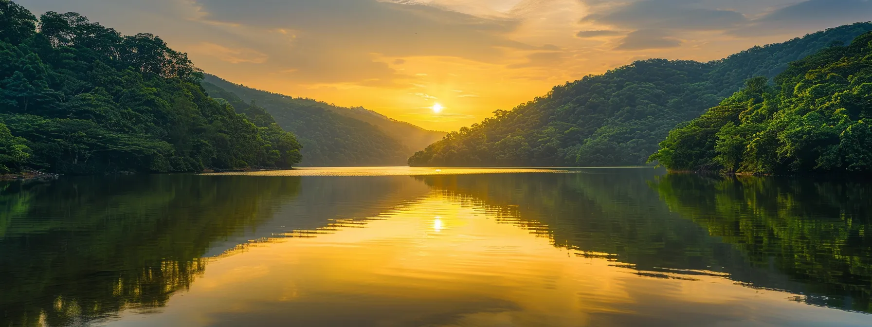 a breathtaking sunset casts a warm golden glow over a tranquil lake, surrounded by lush green mountains reflecting in the crystal-clear water, evoking a sense of peace and serenity.