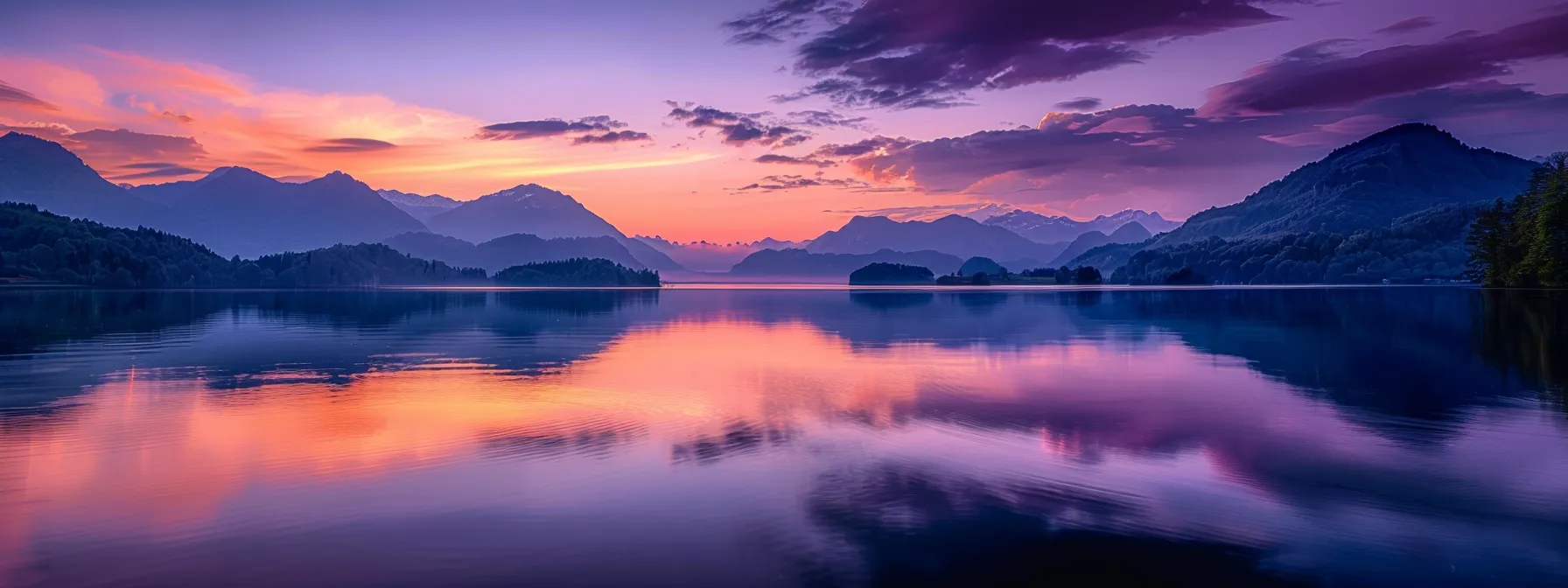 a breathtaking sunset casts vibrant hues of orange and purple over a tranquil lake, reflecting the serene beauty of the surrounding mountains under a clear sky.