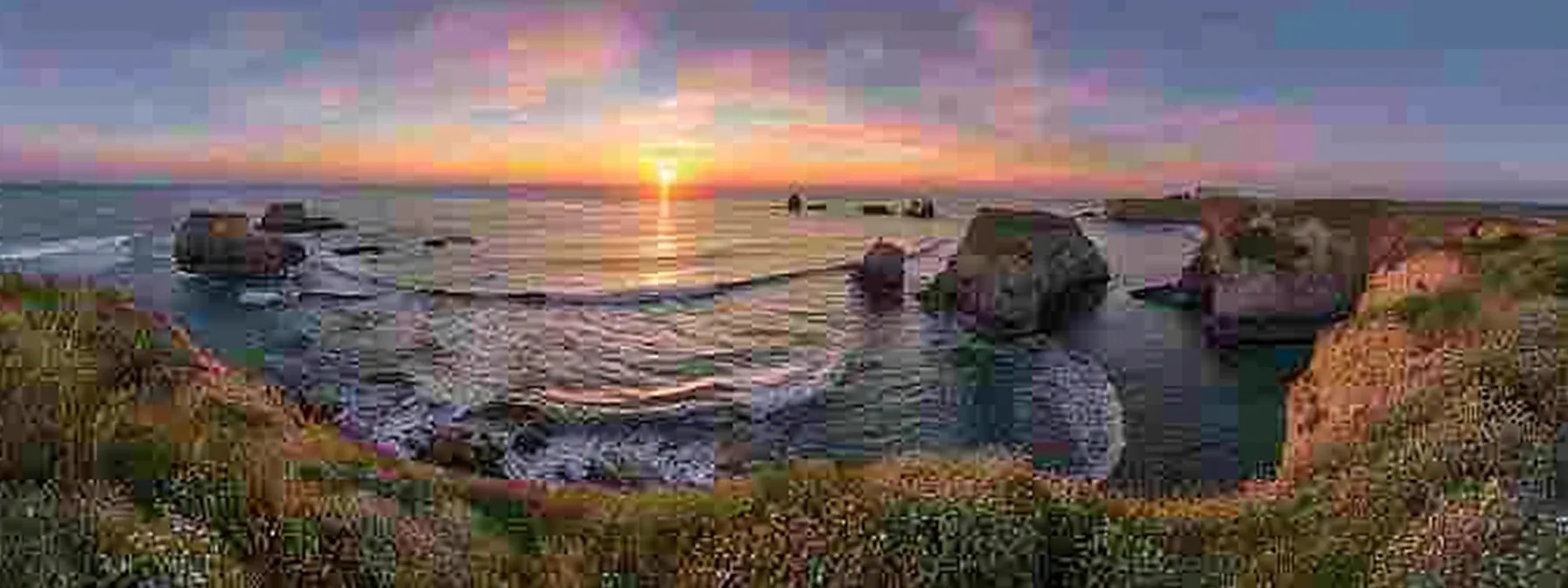 a breathtaking sunset casts vibrant, fiery hues across the tranquil ocean, where gentle waves reflect the colors of the sky in a serene coastal landscape.
