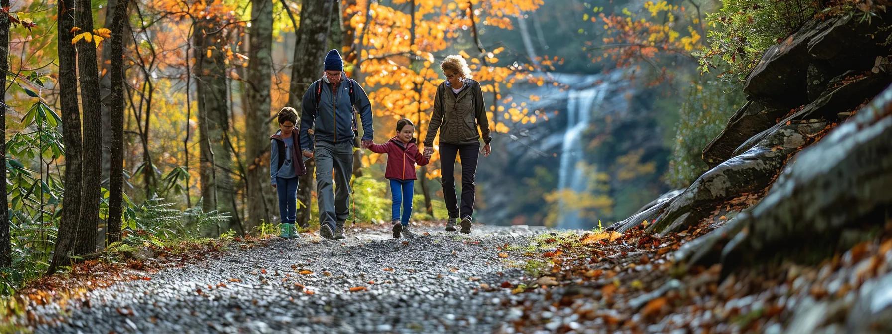 a family navigates a winding, gravel hiking trail surrounded by vibrant autumn foliage in blue ridge, ga, showcasing the stunning vistas of rugged mountains and cascading waterfalls in the background. a family navigates a winding, gravel hiking trail surrounded by vibrant autumn foliage in blue ridge, ga, showcasing the stunning vistas of rugged mountains and cascading waterfalls in the background.