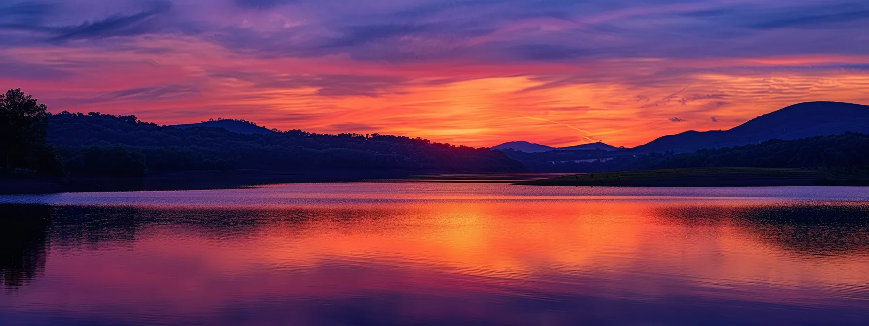 a majestic sunset casts vibrant hues of orange and purple over a tranquil lake, reflecting the serene beauty of nature's splendor. a majestic sunset casts vibrant hues of orange and purple over a tranquil lake, reflecting the serene beauty of nature's splendor.