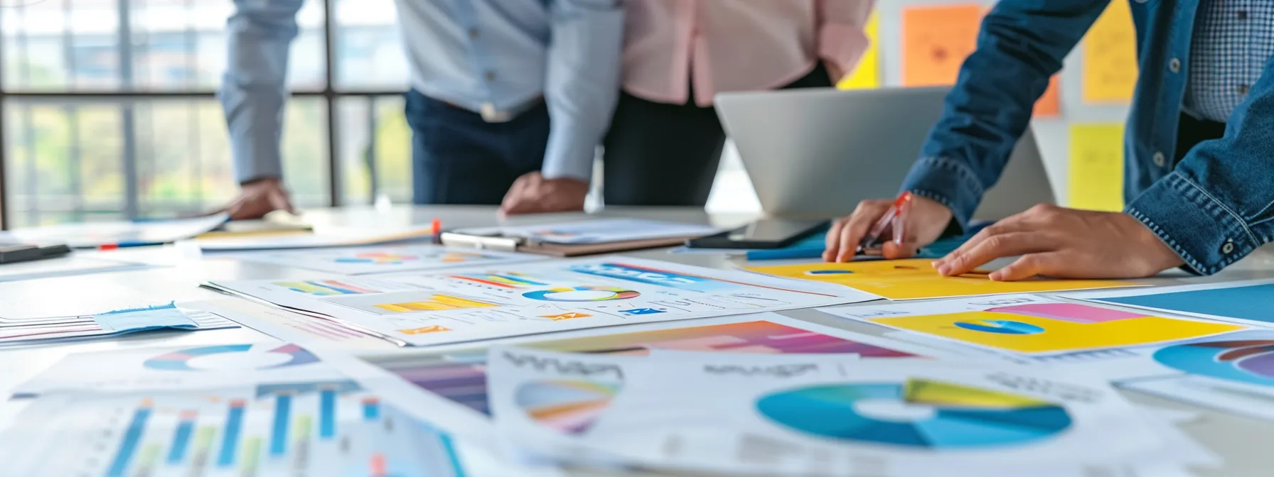 a modern office space buzzes with activity as a focused marketer collaborates around a sleek conference table, surrounded by colorful seasonal ad mock-ups and digital devices displaying dynamic ppc campaign strategies.