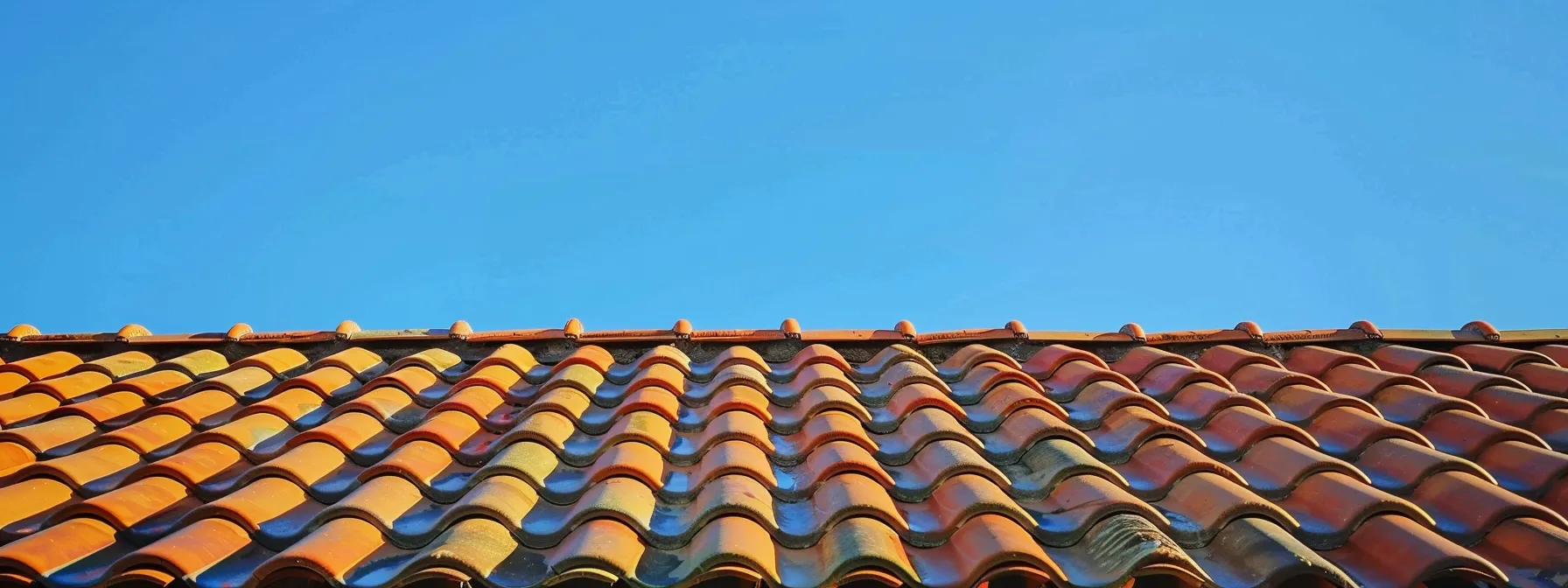 a pristine, freshly pressure-washed roof gleams under the warm afternoon sun, showcasing its vibrant colors and impeccable cleanliness against a clear blue sky. a pristine, freshly pressure-washed roof gleams under the warm afternoon sun, showcasing its vibrant colors and impeccable cleanliness against a clear blue sky.
