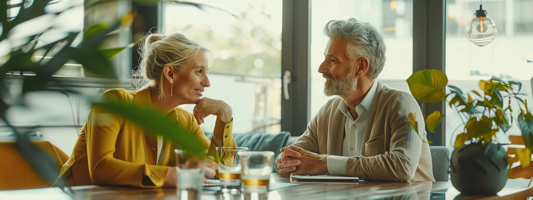 a stylishly modern office setting showcases a 50+ couple engaged in a lively discussion about the sound quality differences between phonak and jabra hearing aids, with sleek hearing aid models prominently displayed on a polished conference table.