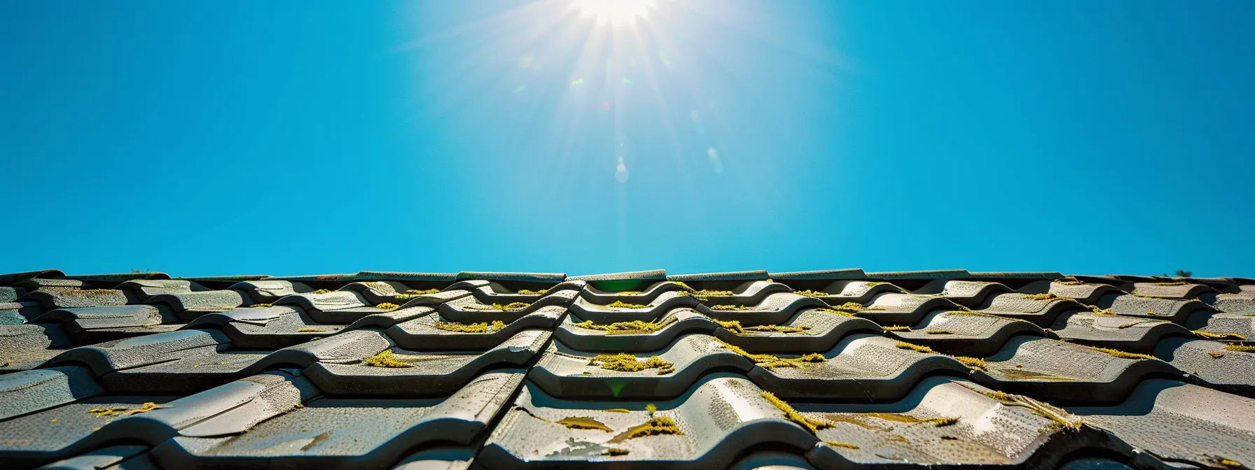 a vibrant, sunlit roof glistens after a thorough pressure washing, revealing clean, moss-free shingles against a bright blue sky, symbolizing the proactive maintenance that prolongs its lifespan. a vibrant, sunlit roof glistens after a thorough pressure washing, revealing clean, moss-free shingles against a bright blue sky, symbolizing the proactive maintenance that prolongs its lifespan.