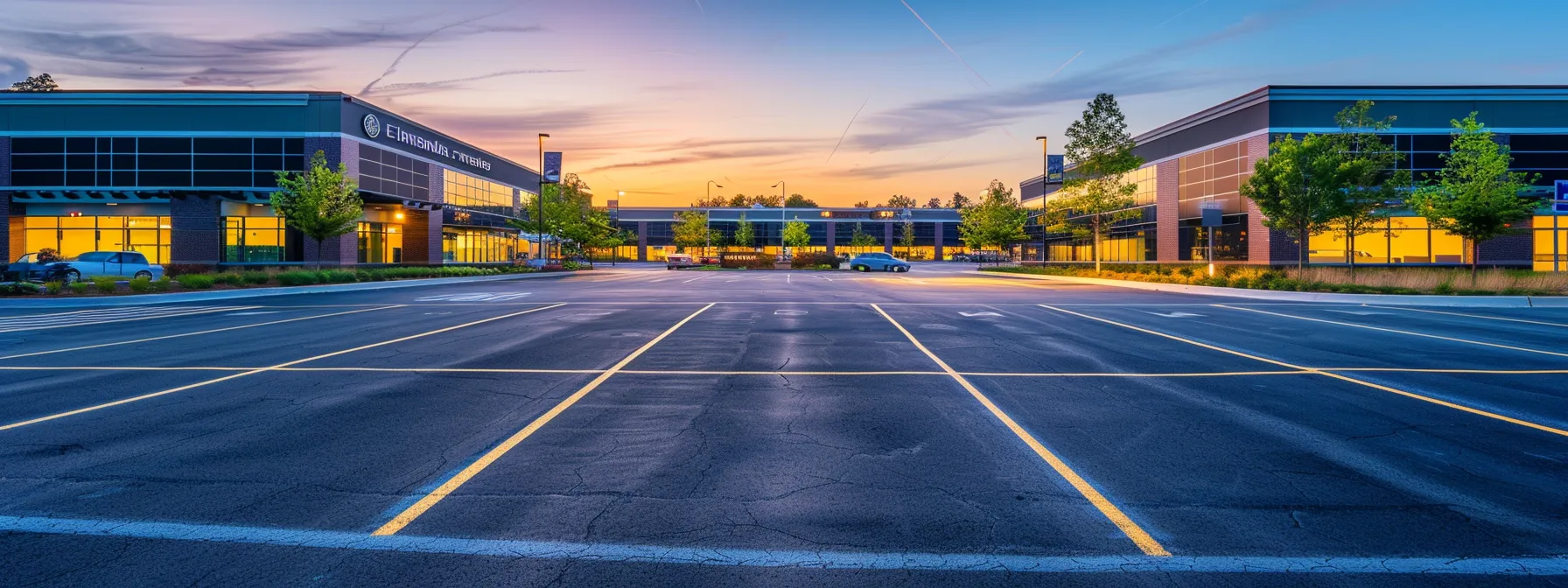 a well-maintained commercial parking lot, with freshly painted clear lines and visible safety signage, showcasing professional-grade pavement and a bustling backdrop of local businesses ensuring a secure environment for employees and customers.