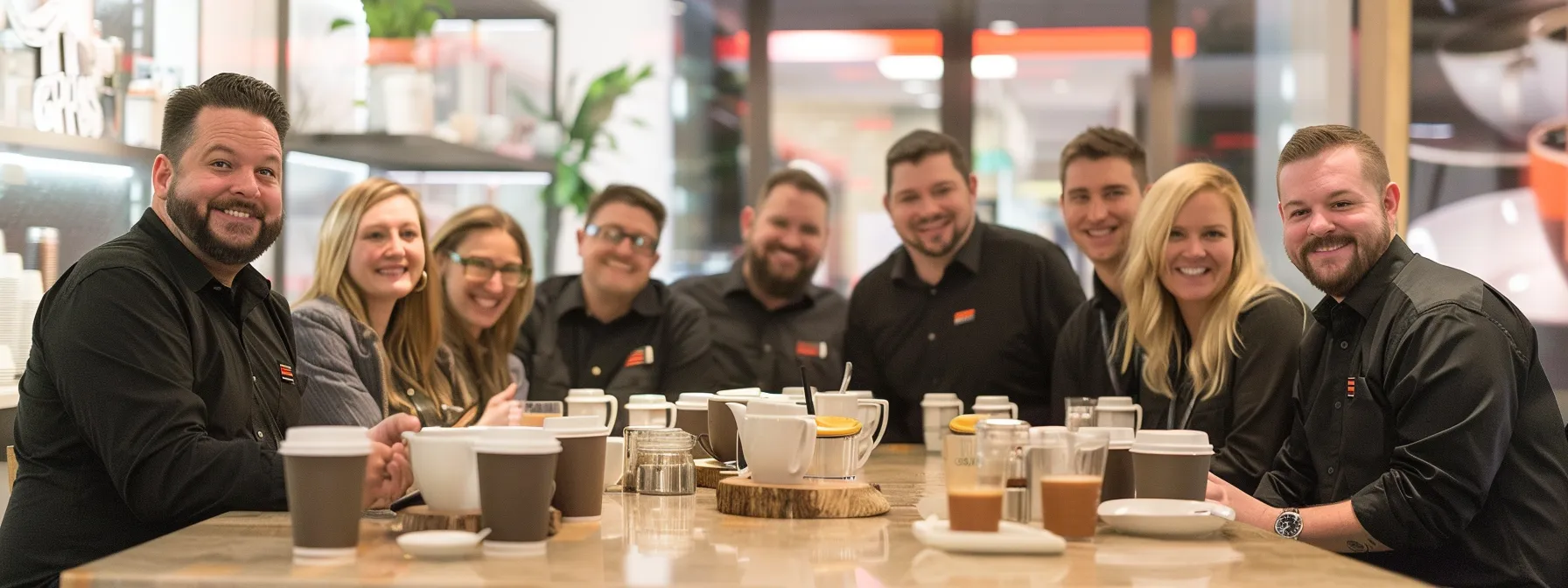a group of smiling employees enjoying freshly brewed coffee in a modern office setting, showcasing necco coffee's positive impact on overland park companies.