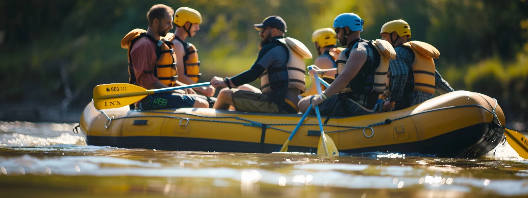 a group of experienced rafters and guides mentoring a newcomer on the riverbank under the sunny sky.